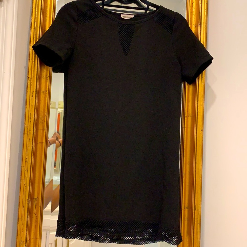 Black mini dress with fishnet accents